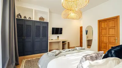 a bedroom with a bed and a chandelier at Villa Baccarat - Piscine et Luxe in Marrakech