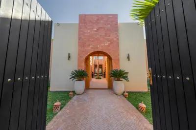 a hallway with two potted plants in a building at Villa Baccarat - Piscine et Luxe in Marrakech
