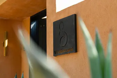 a sign on the side of a building at Villa Baccarat - Piscine et Luxe in Marrakech