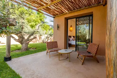 two chairs and a table on a patio at Villa Baccarat - Piscine et Luxe in Marrakech