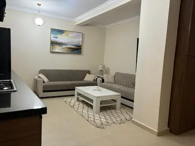 a living room with a couch and a table at Joli appartement à Gueliz in Marrakech