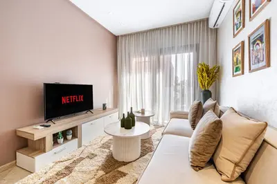 a living room with a couch and a tv at Bohochic#appartement#Gueliz in Marrakech