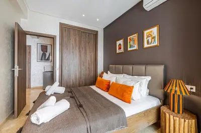 a bedroom with a large bed with orange and white pillows at Bohochic#appartement#Gueliz in Marrakech