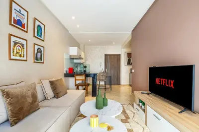 a living room with a couch and a television at Bohochic#appartement#Gueliz in Marrakech