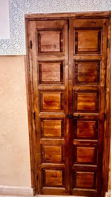 a wooden cabinet with many drawers in a room at Dar Rahma- old Town Marrakech in Marrakech