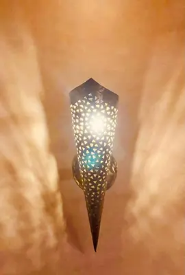 a lamp hanging from a ceiling with a light at Dar Rahma- old Town Marrakech in Marrakech