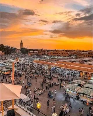 a crowd of people walking around a market at sunset at Dar Rahma- old Town Marrakech in Marrakech