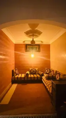 a living room with a couch in the corner of a room at Dar Rahma- old Town Marrakech in Marrakech