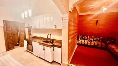 a kitchen with a sink and a couch in a room at Dar Rahma- old Town Marrakech in Marrakech
