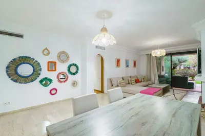 a living room with a table and a couch at Appartement de charme residence avec piscine WiFi in Marrakech
