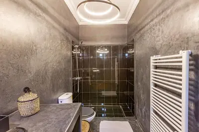 a bathroom with a shower with a toilet and a sink at Private villa Comfort and Relax Pool in Marrakech