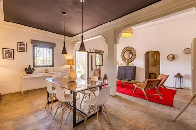 a dining room and living room with a table and chairs at Private villa Comfort and Relax Pool in Marrakech