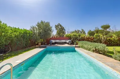 a swimming pool in a yard with a couch in it at Private villa Comfort and Relax Pool in Marrakech