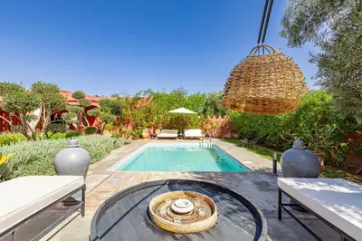 a swimming pool in a backyard with a table and chairs at Private villa Comfort and Relax Pool in Marrakech