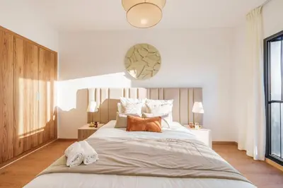a bedroom with a large bed with two pillows at Elegance and Serenity at Noria Golf and Pool view in Marrakech