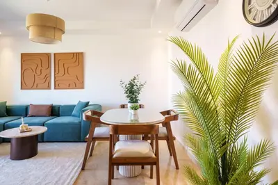 a living room with a blue couch and a table at Elegance and Serenity at Noria Golf and Pool view in Marrakech