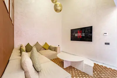 a living room with a couch and a tv at Duplex Luxury and Comfort in Heart of Gueliz in Marrakech