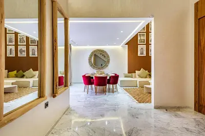 a dining room with a table and red chairs at Duplex Luxury and Comfort in Heart of Gueliz in Marrakech