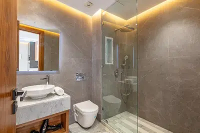 a bathroom with a shower and a toilet and a sink at elegance et modernite au coeur de la ville in Marrakech