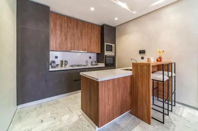 a kitchen with wooden cabinets and a counter top at Bohemian Style in Hyper-Center - Optical Fiber in Marrakech