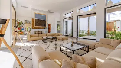 a living room with a couch and a table at VilLA AYDEN in Marrakech