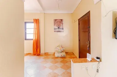 a room with an orange curtain and a door at Appartement à Marrakech in Marrakech