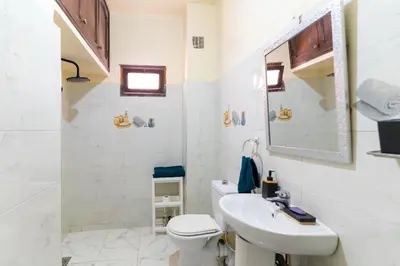 a white bathroom with a sink and a toilet at Appartement à Marrakech in Marrakech