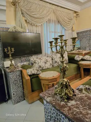 a living room with a couch and a tv at cozy Apartment Near Airport in Marrakech