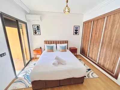 a bedroom with a bed with two towels on it at New Apartment in Guéliz, Pool, Balcony & Parking in Marrakech