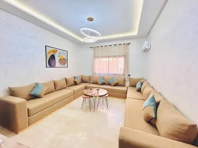 a living room with a couch and a table at New Apartment in Guéliz, Pool, Balcony & Parking in Marrakech