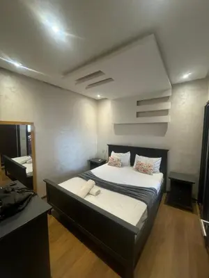 a bedroom with a large bed in a room at Cosy-Appart in Marrakech