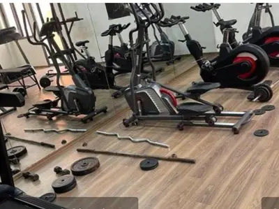 a gym with several exercise bikes on a wooden floor at Cosy-Appart in Marrakech
