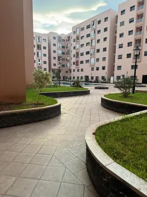 a courtyard in a large building with buildings at Cosy-Appart in Marrakech