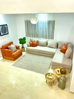 a living room with a couch and a table at Duplex chic et cosy avec piscine in Marrakech