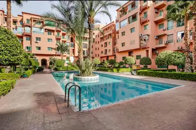 a swimming pool in front of a building at Appart hôtel avec piscine in Marrakech