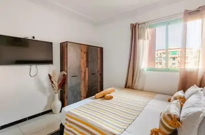 a bedroom with a bed with a teddy bear on it at Appart hôtel avec piscine in Marrakech