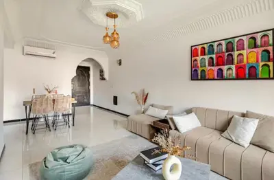a living room with a couch and a table at Appart hôtel avec piscine in Marrakech