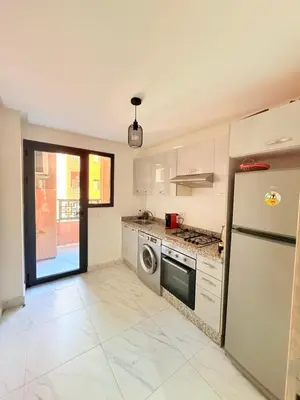 a kitchen with a refrigerator and a dishwasher at STUDIO luxueux COSY FAMILY in Marrakech