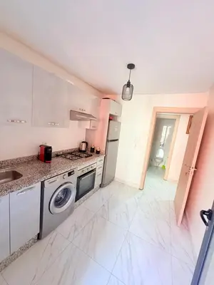 a kitchen with a sink and a dishwasher at STUDIO luxueux COSY FAMILY in Marrakech