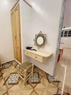 a room with a dressing table and two chairs and a mirror at Neuf appartement a marrakech in Marrakech