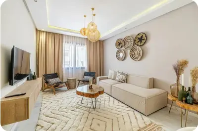 a living room with a couch and a tv at Appartement en hyper Centre in Marrakech