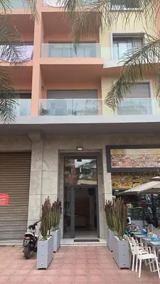 a building with a motorcycle parked in front of it at Appartement en hyper Centre in Marrakech