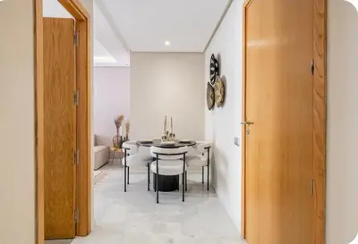 a dining room with a table and chairs at Appartement en hyper Centre in Marrakech