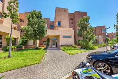 a motorcycle parked in front of a building at Elevated Elegance A Stylish Golf Atlas Apartment in Marrakech