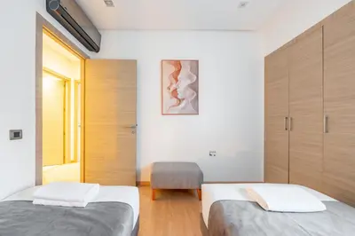 two beds in a room with wooden cabinets at Luxury Prestigia Paradise Garden-Pool in Marrakech