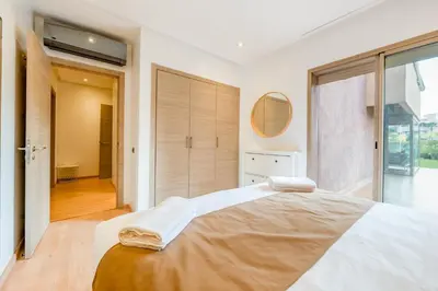a bedroom with a large bed and a large window at Luxury Prestigia Paradise Garden-Pool in Marrakech