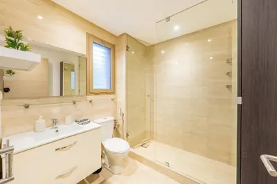 a bathroom with a shower and a toilet and a sink at Luxury Prestigia Paradise Garden-Pool in Marrakech