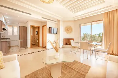 a living room with a couch and a table at Luxury Apartment in Vizir Park & Resort in Marrakech