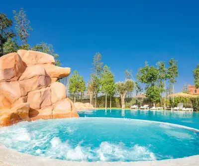 a pool at a resort with a water slide at Luxury Apartment in Vizir Park & Resort in Marrakech