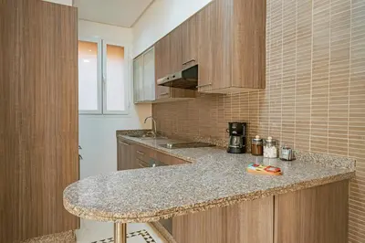 a kitchen with a counter and a counter top at Luxury Apartment in Vizir Park & Resort in Marrakech